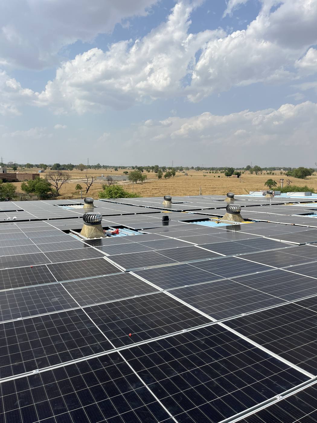 Large tin-shed solar plant next to open fields