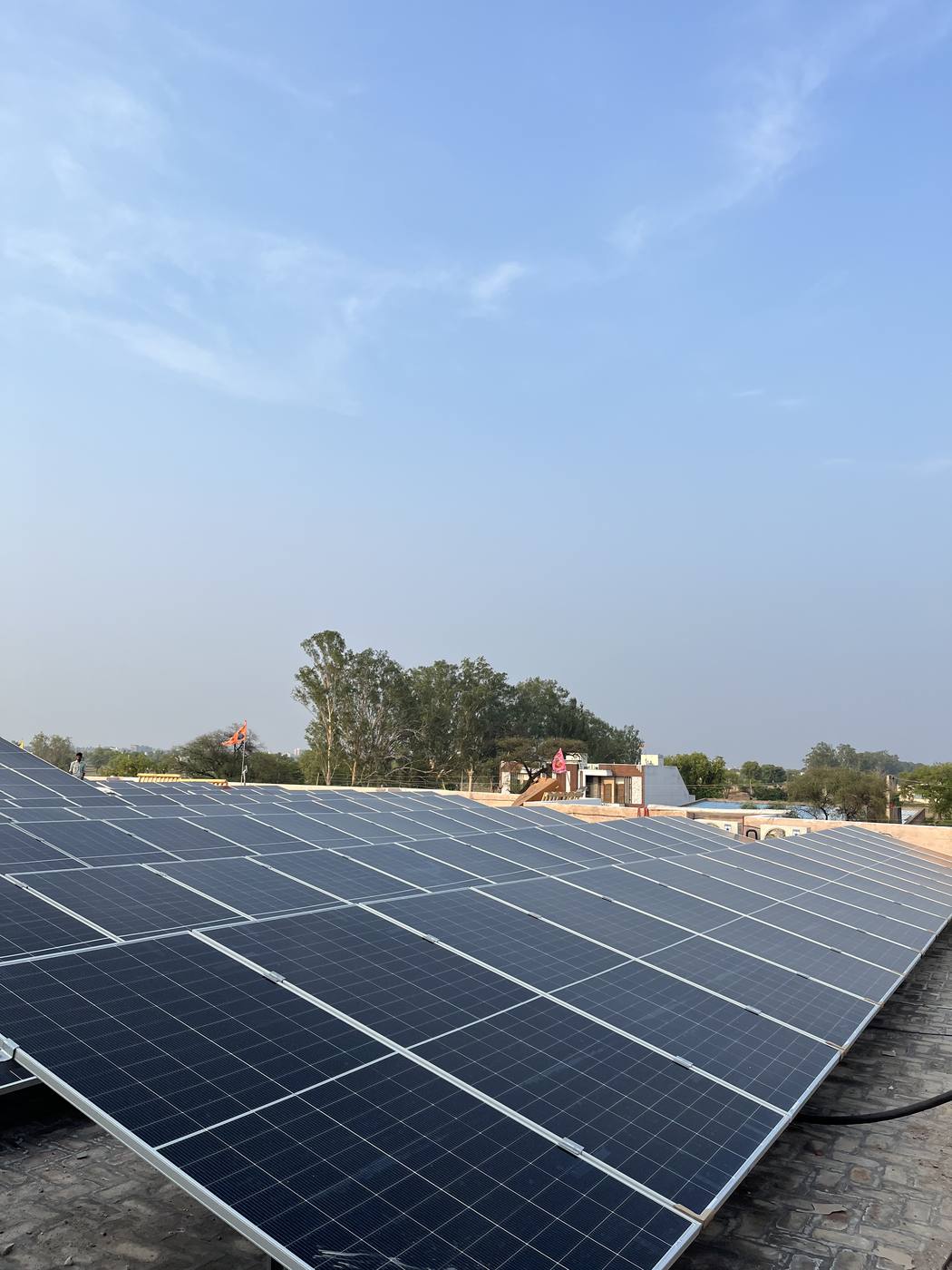 Rooftop solar array under blue sky